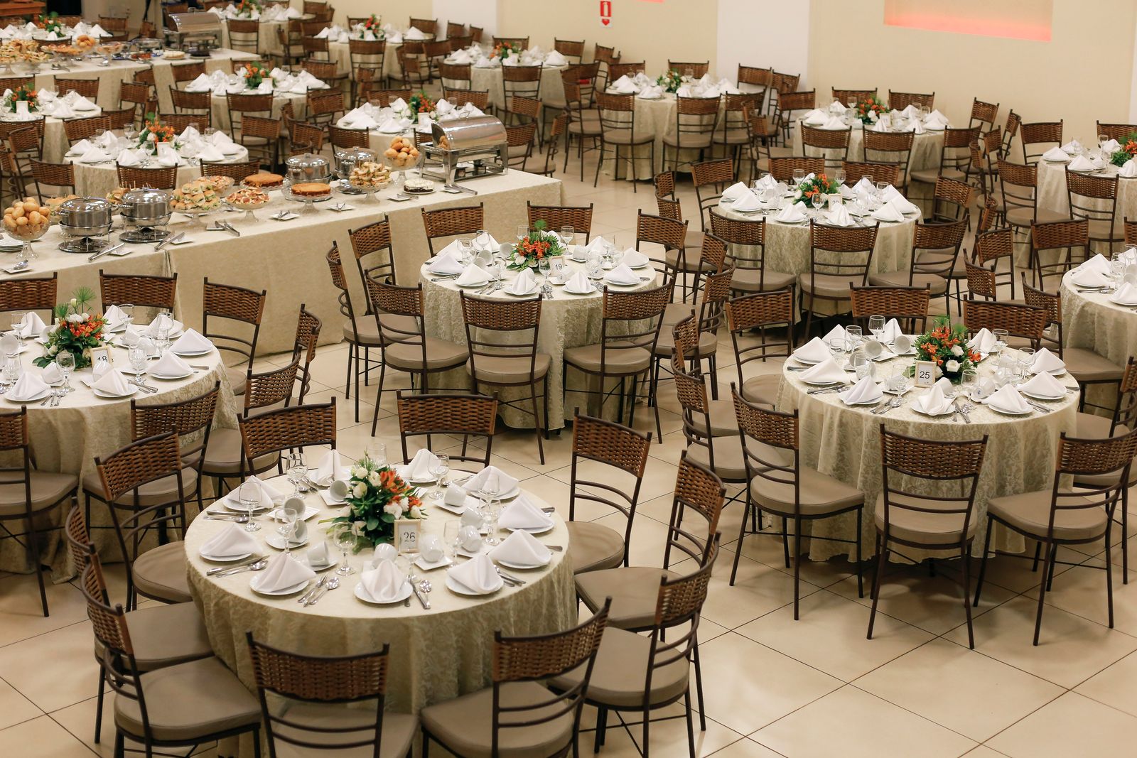 Banquet hall set with round tables for an event.