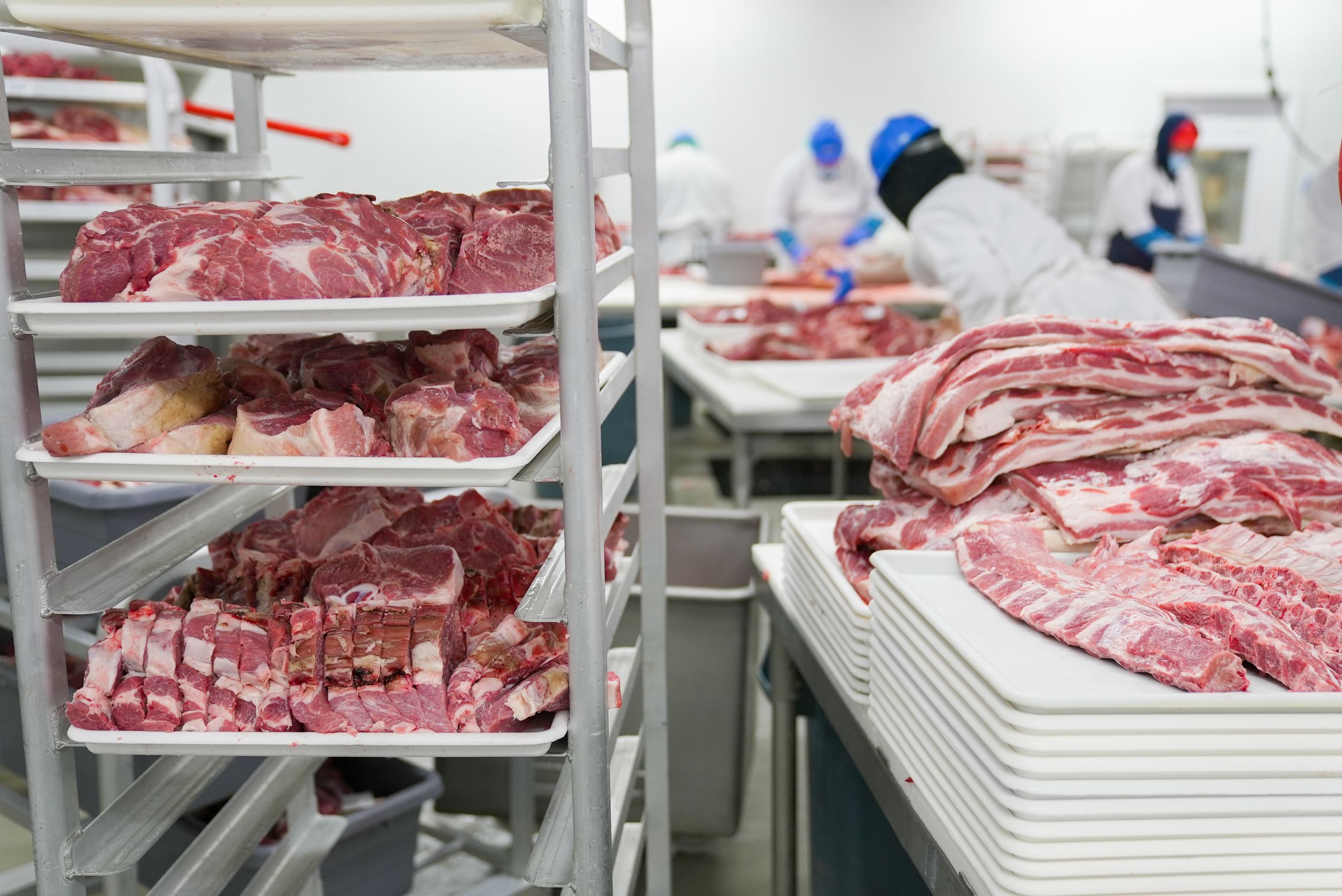 Meat products on racks in a processing plant.