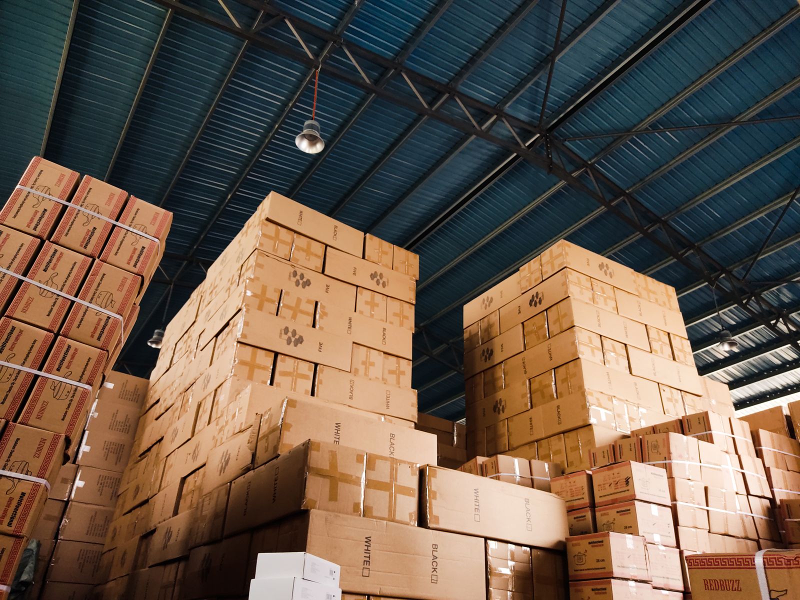 Cartons stacked high in a warehouse.