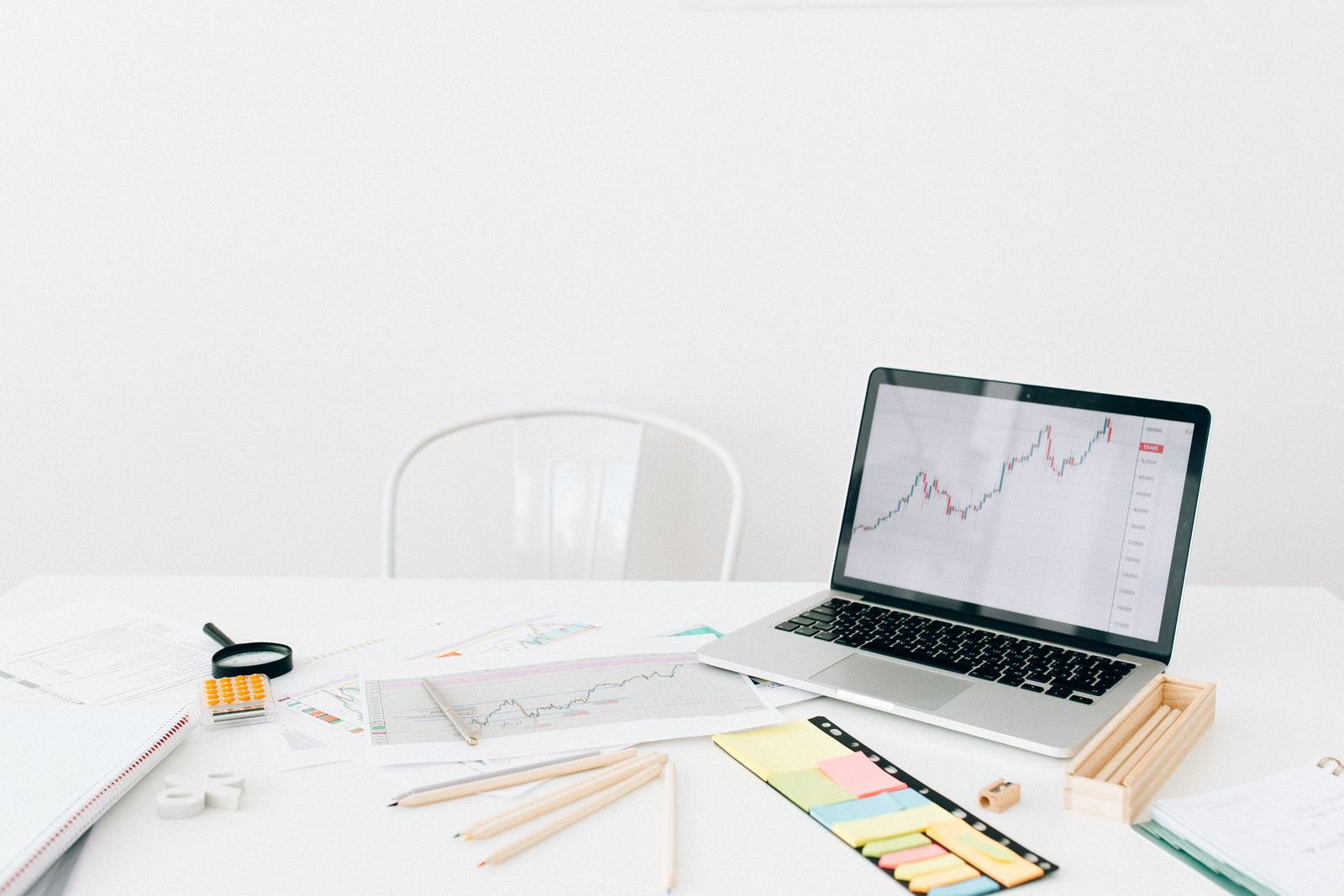 Workstation with a laptop showing a chart.
