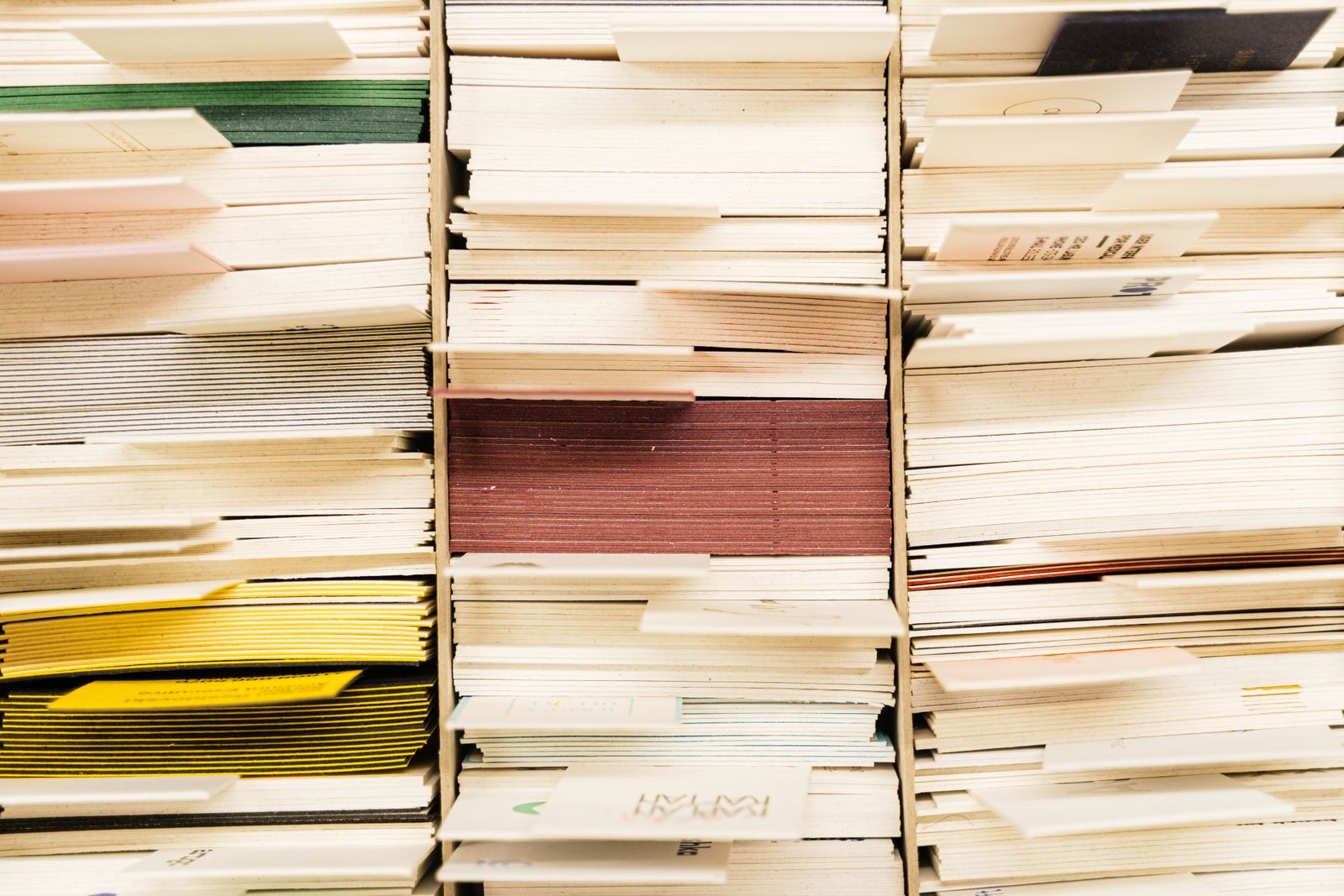 Stacks of paper records filling a set of shelves.