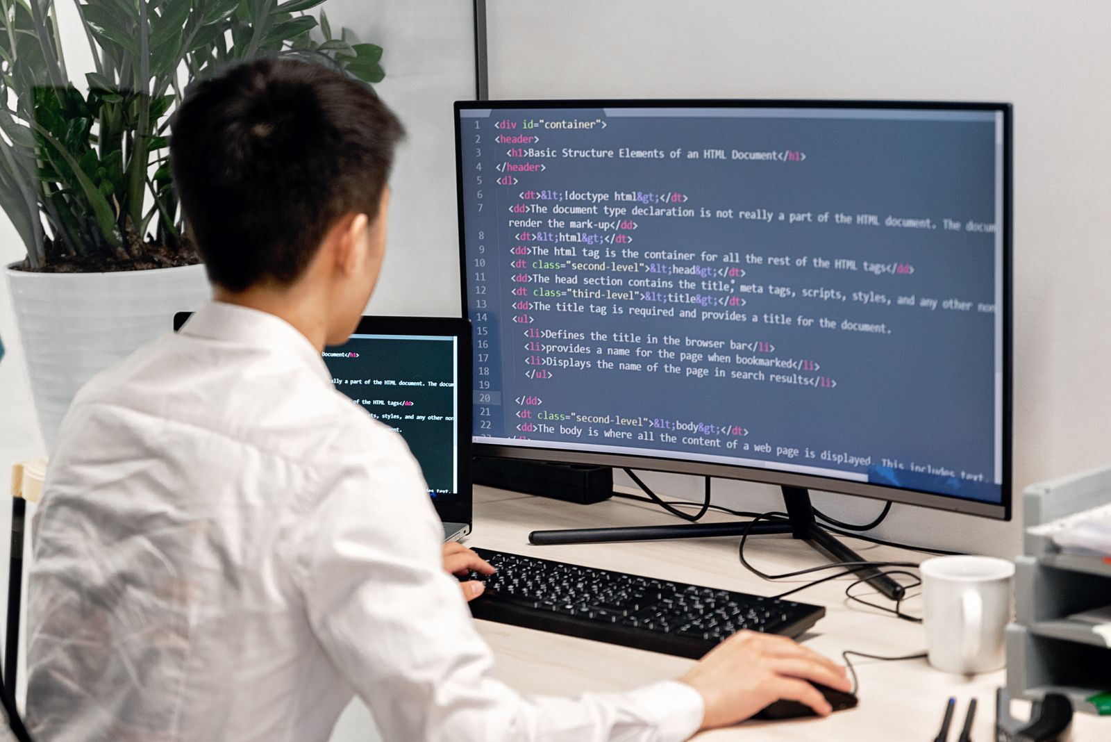 Developer working at a wide monitor.