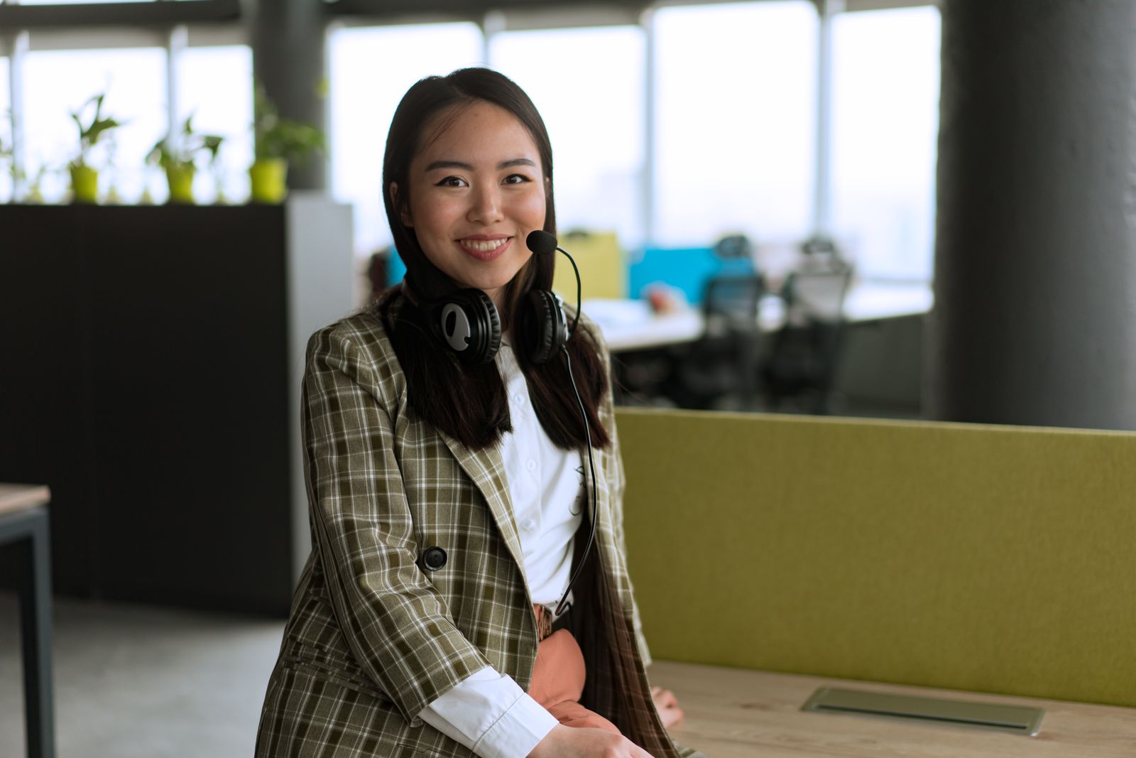 Support specialist with a headset, smiling.